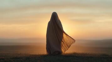 figure draped in cloak stands against stunning sunset, evoking sense of mystery and tranquility photo