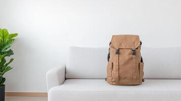 Cozy backpack resting on sofa in minimalist living space, adding warmth to room photo