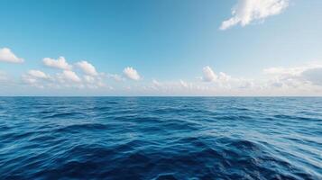 Calm ocean waves reflect serene blue sky with fluffy clouds above photo