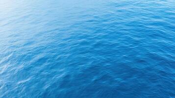 Calm ocean surface with gentle waves reflecting sunlight, creating serene atmosphere photo