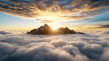 Majestic mountain peaks rise above sea of clouds at sunset, creating ethereal atmosphere photo