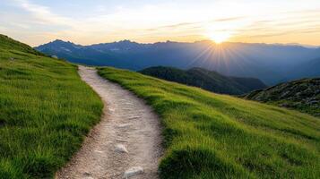 scenic mountain trail winding through lush green grass at sunset, offering peaceful atmosphere photo