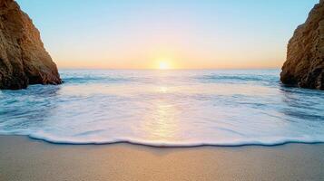 Sunset over ocean waves gently lapping sandy beach between cliffs, creating serene atmosphere photo