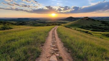 scenic trail leads through lush green hills under vibrant sunset, creating serene atmosphere photo