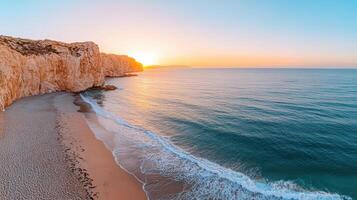 Golden hour illuminates ocean cliffs and calm waves at serene beach photo