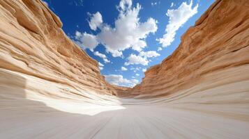 A desert canyon with a blue sky and clouds photo