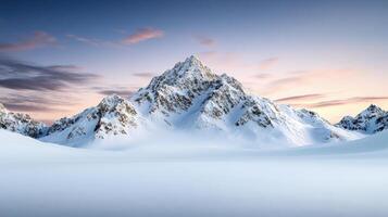 A snowy mountain landscape with a sunset photo