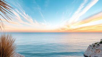 Vivid sunset over calm ocean horizon with colorful clouds reflecting on water photo