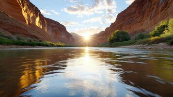 Breathtaking sunset over canyon river, with light reflecting on water surface photo