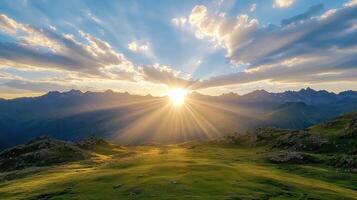 Breathtaking sunset behind mountain ridge with beams of light illuminating landscape photo