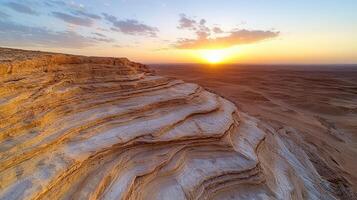 Stunning sunset over desert cliffs with layered sandstone formations and vast landscape photo
