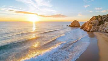 The sun sets over the ocean and beach in cabo san lucas, mexico photo