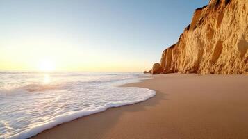 Golden beach with cliffs at sunset, waves gently crashing on shore, creating serene atmosphere photo
