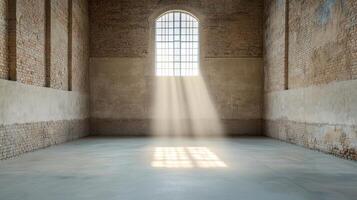 Bright light streams through large window, illuminating spacious, empty room with brick walls photo