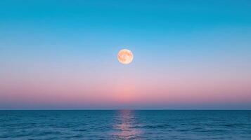 Serene ocean view with full moon rising over water, creating tranquil atmosphere photo