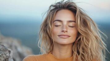 Gently smiling woman with closed eyes, enjoying serene mountain breeze photo