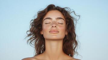 A woman with her eyes closed and her face open photo