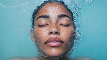 A woman with freckles under water photo