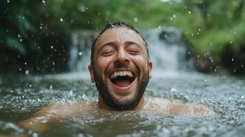 A man is laughing in the water while smiling photo