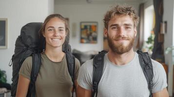A man and woman with backpacks standing in a room photo