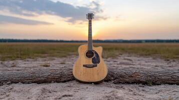 Acoustic guitar resting on log at sunset with serene ambiance photo