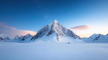 Majestic mountain peak surrounded by snow and blue sky, creating serene atmosphere photo