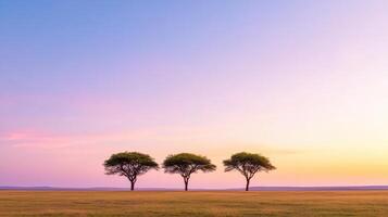 Majestic trees silhouetted against soft purple and pink twilight sky create serene landscape photo