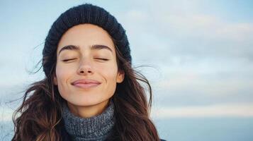 Calm expression with closed eyes, enjoying breeze and nature beauty photo
