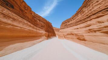 Winding trail through colorful layered canyon with vibrant rock formations and clear blue sky photo