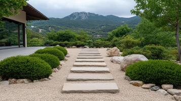 Serene stone path leading through zen garden with lush greenery and mountains in background photo