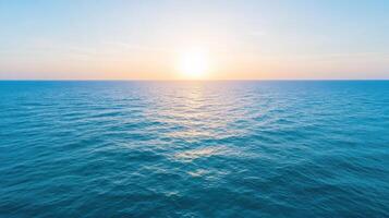 Serene ocean view at sunset with gentle waves reflecting sunlight creates peaceful atmosphere photo
