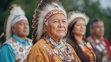 Native american elder standing in front of other people photo