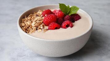 A bowl of yogurt with raspberries and granola photo
