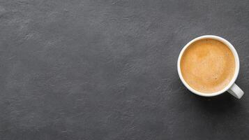 Top view of a cup of coffee on a black background photo