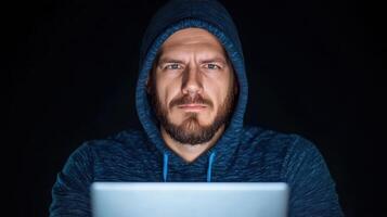 Focused investigator analyzing dark web activity with laptop, showcasing determination photo