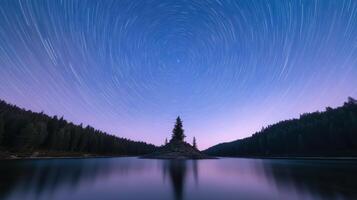 Long exposure captures star trails over serene lake with solitary tree island photo