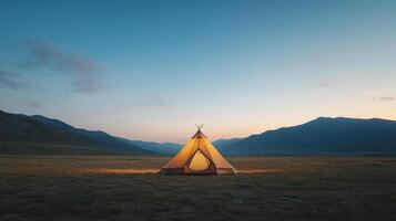 Serene tent in valley at twilight, surrounded by mountains and starry sky photo
