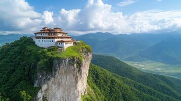 Majestic cliffside monastery surrounded by lush mountains and blue skies, offering tranquility photo