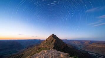 Majestic canyon view with star trails above, showcasing nature beauty and tranquility photo