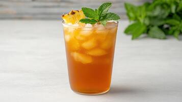 A glass of iced tea with a pineapple on top photo