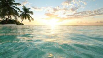 Tropical beach with palm trees and the sun setting photo