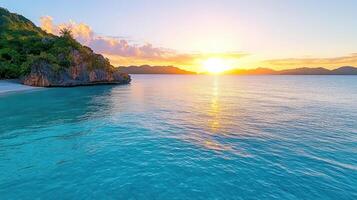 The sun sets over the ocean and a beach photo