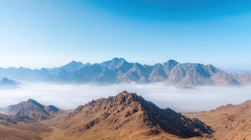 Mountains in the desert with low clouds photo