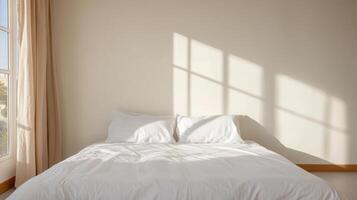 A white bed with white sheets and pillows in front of a window photo
