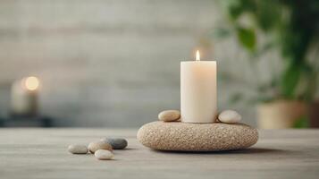 Candle and stones on wooden table with potted plants photo