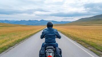 A person riding a motorcycle down a country road photo