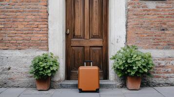 An orange suitcase sits on the ground next to a door photo