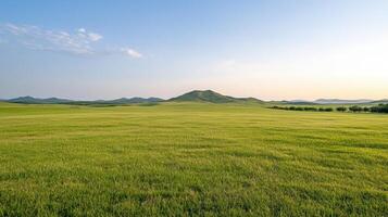 A grassy field with hills in the background photo