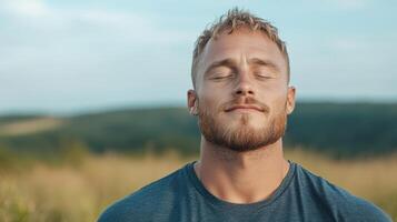A man with his eyes closed in a field photo