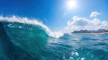 A wave breaking on the ocean with a blue sky photo